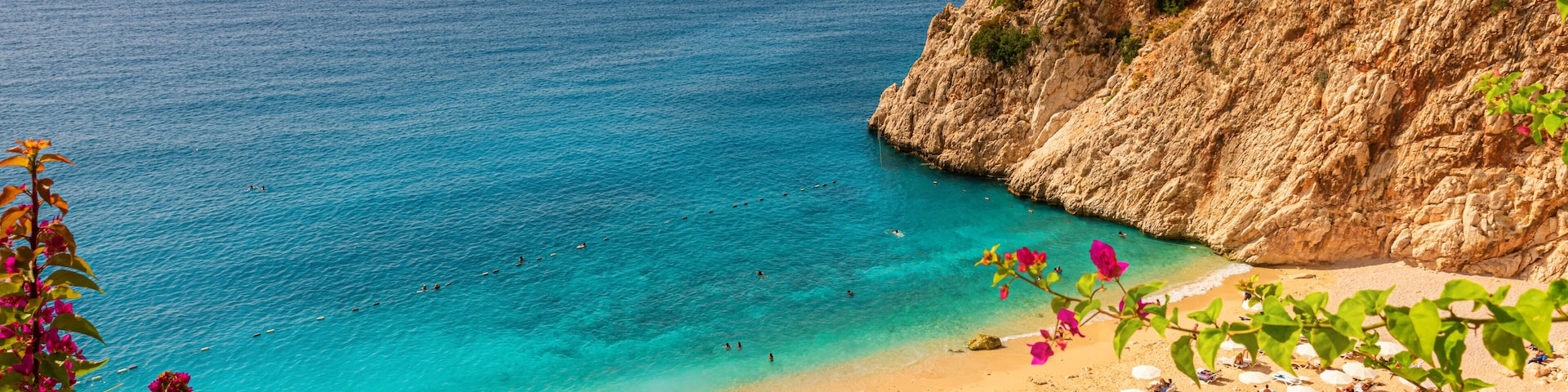 Kaputas beach with blue water on the coast of Antalya region in Turkey with sun umbrellas on the beach