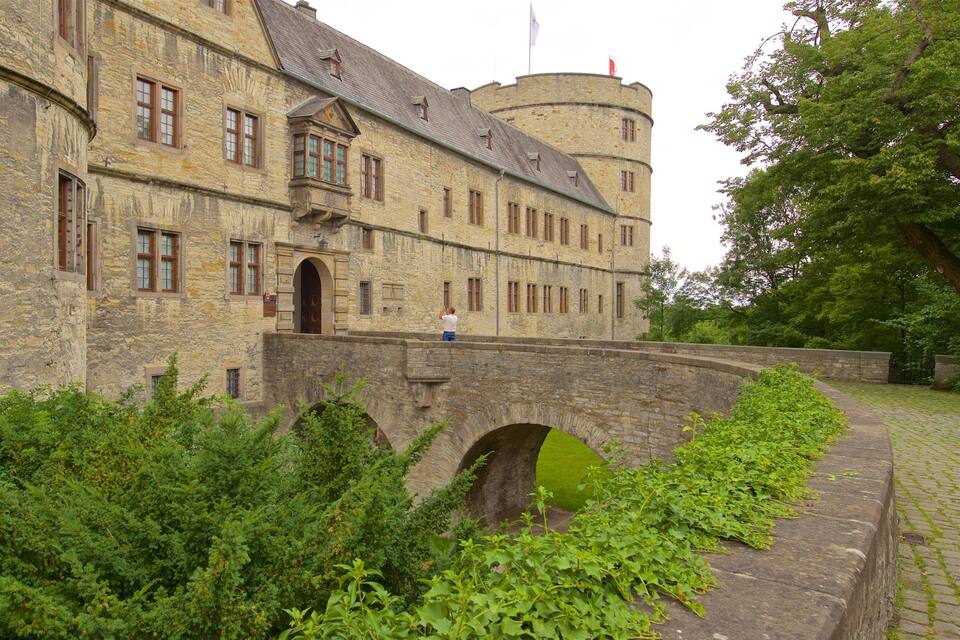 A historic stone building with a turret and a bridge.