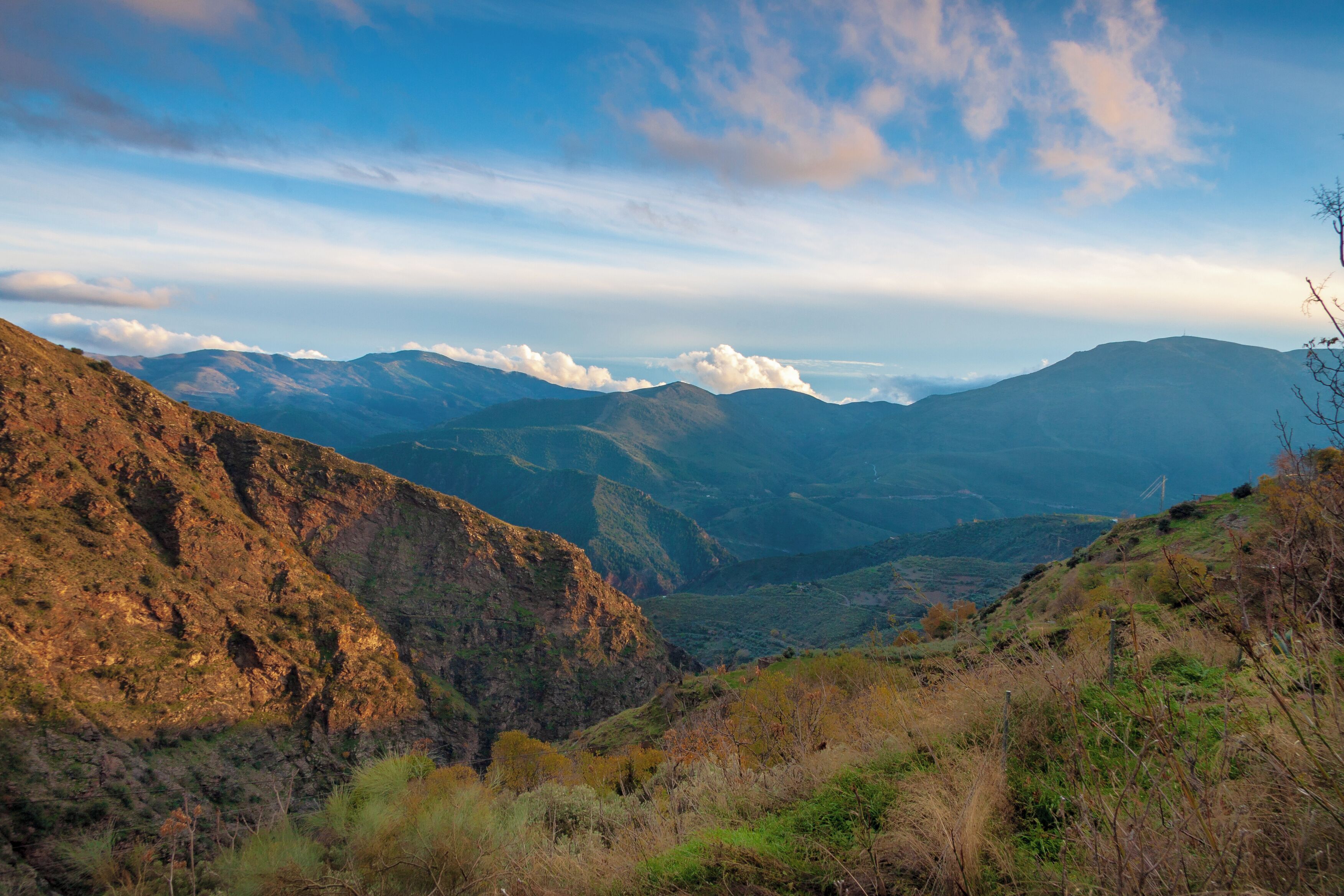 A mountainous landscape with rugged terrain and a valley.