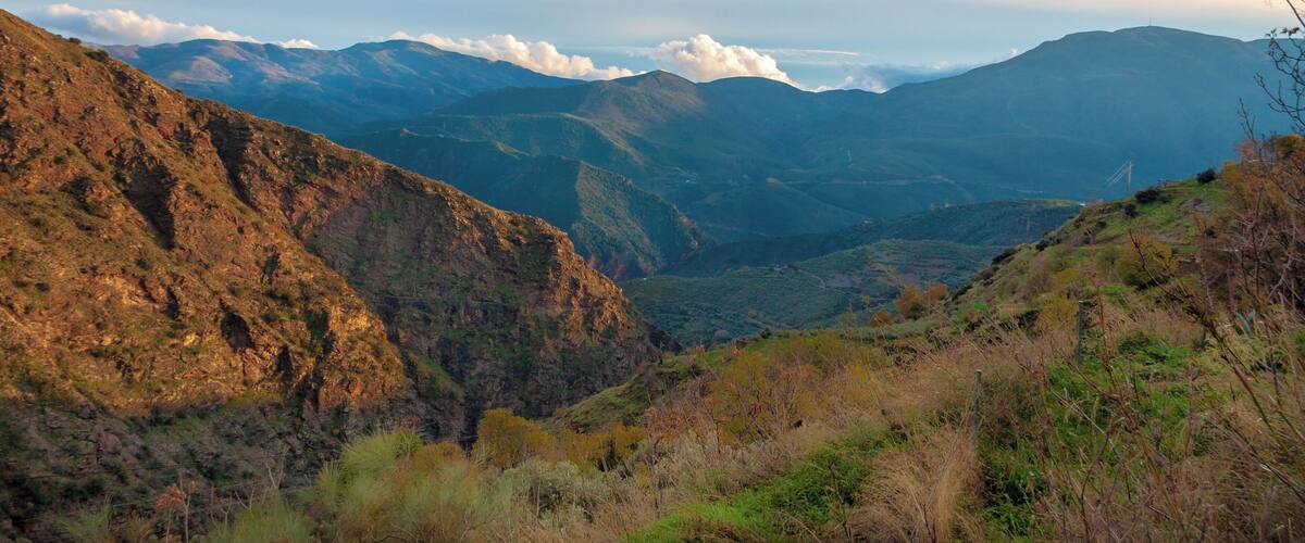 A mountainous landscape with rugged terrain and a valley.