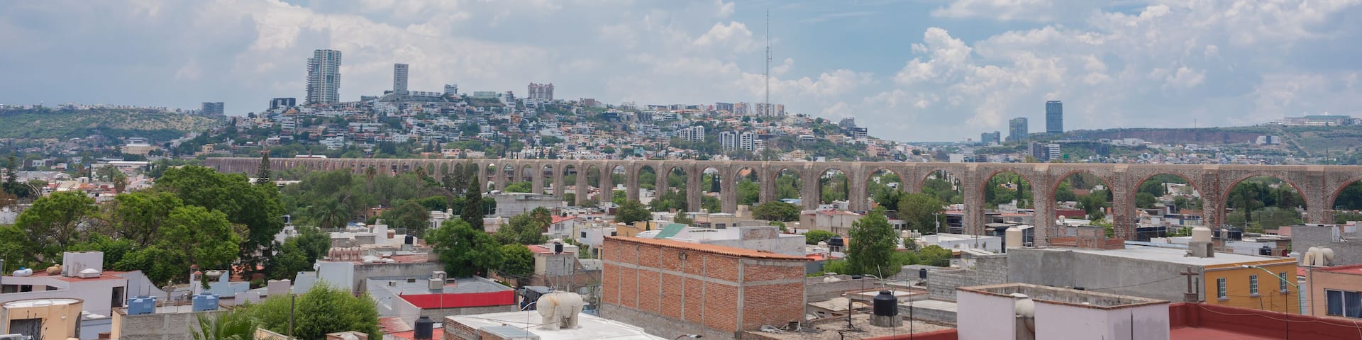queretaro mexico city landscape photography, mexican city, queretearo aqueduct view, buildings, houses, blue sky with clouds