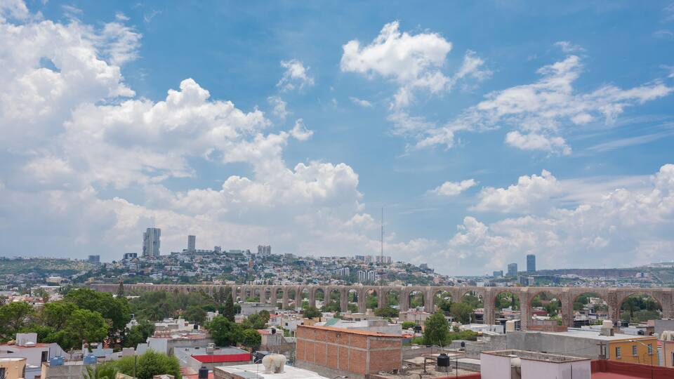 queretaro mexico city landscape photography, mexican city, queretearo aqueduct view, buildings, houses, blue sky with clouds