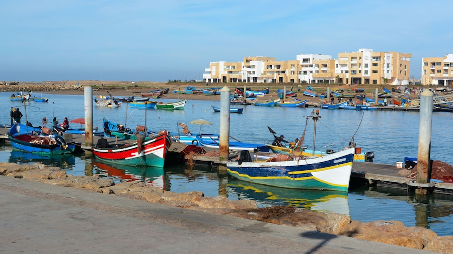Rabat, Morocco - December 26, 2015: New exclusive apartment buildings at Bouregreg Marina in Rabat. Traditional blue fishing boats in the foreground.