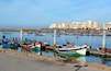 Rabat, Morocco - December 26, 2015: New exclusive apartment buildings at Bouregreg Marina in Rabat. Traditional blue fishing boats in the foreground.