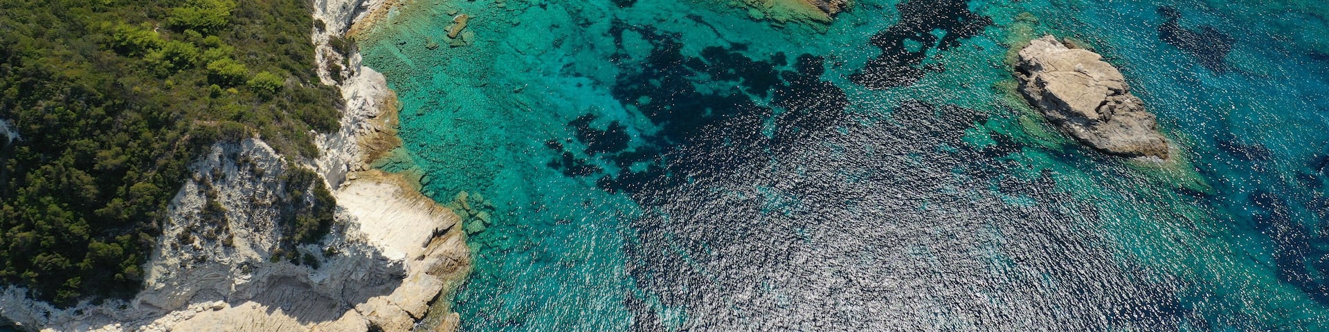 Aerial drone photo of paradise bay and village of Laka visited by yachts and sail boats, island of Paxos, Ionian, Greece