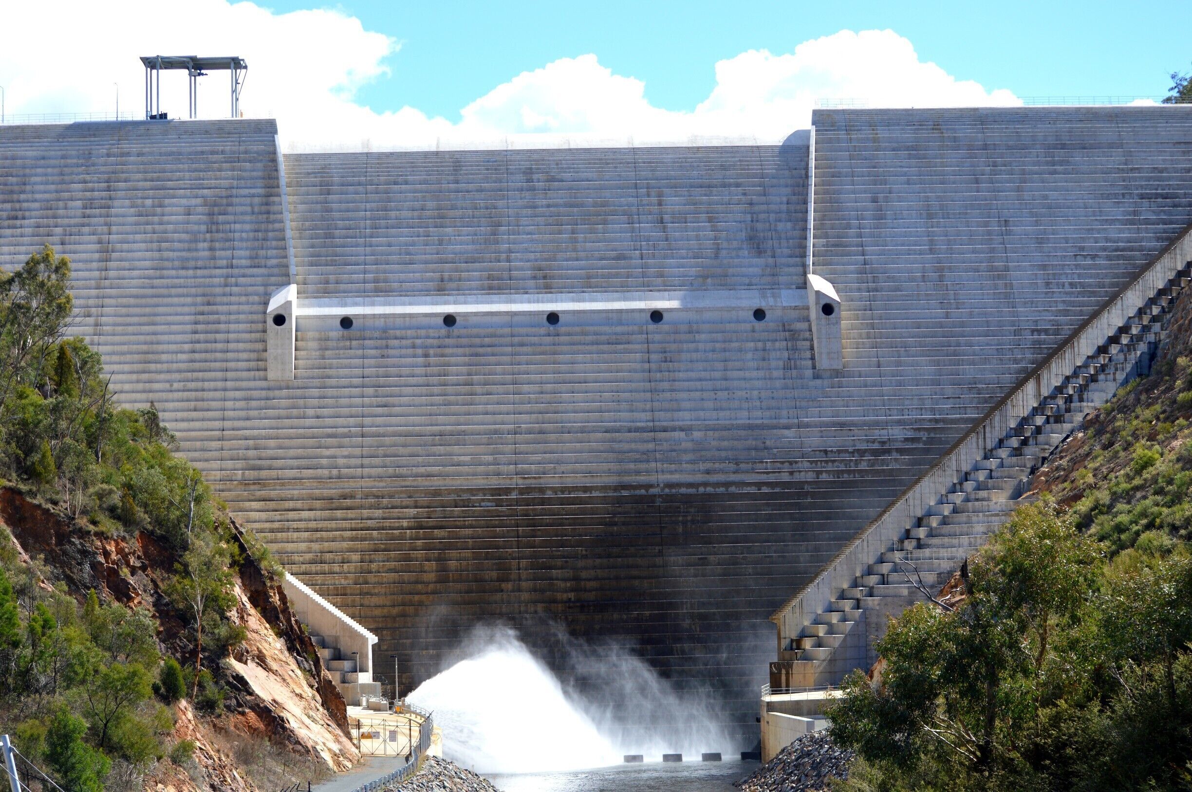 A short walk along the discovery trail to see Cotter Dam. 
Along the trail, there is the story of how Canberra receives its water and the importance of Cotter Reserve in its planning. At the end of the short trail, you will be amazed to find the 16 metre wide viewing platform overlooking the dam itself. Hard to believe the water level is to the very top on the rim especially when you are standing well below.

