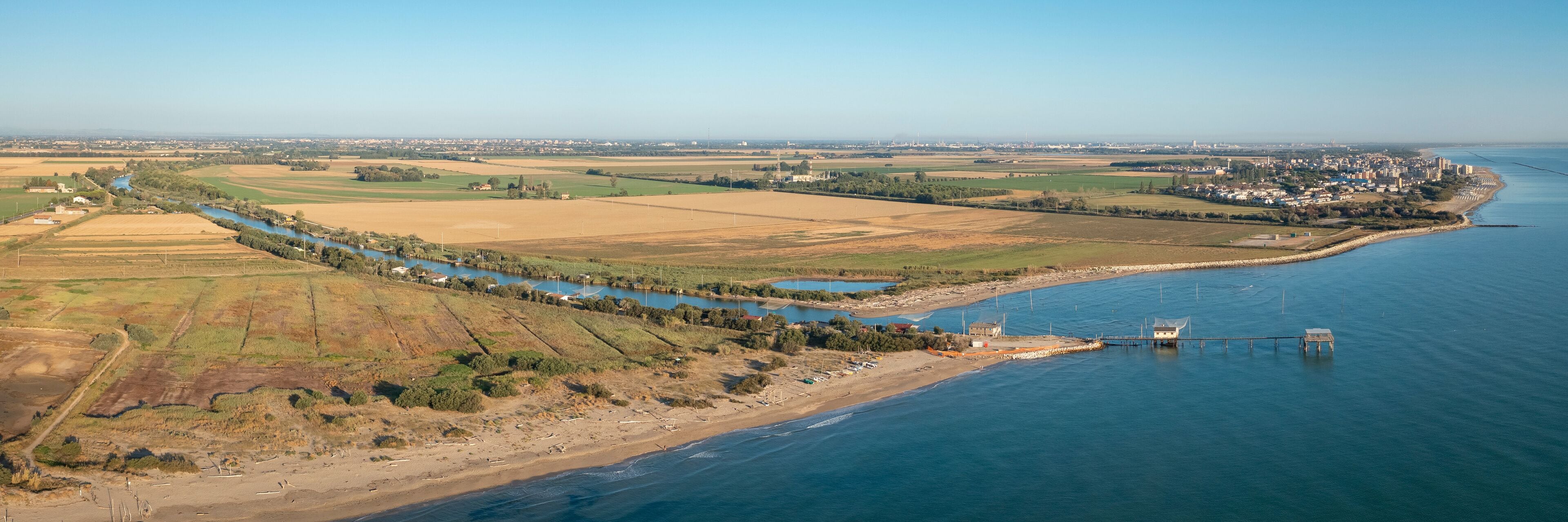 Aerial shot of fishing huts with typical italian fishing machine, called "trabucco",Lido di Dante, Fiumi Uniti, Ravenna near Comacchio valley.
