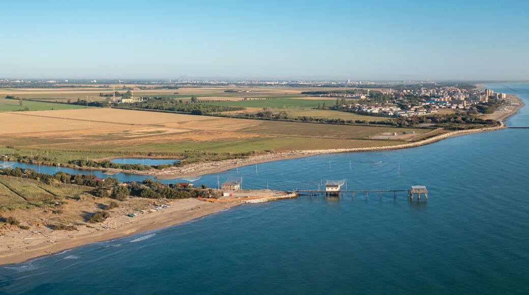Aerial shot of fishing huts with typical italian fishing machine, called "trabucco",Lido di Dante, Fiumi Uniti, Ravenna near Comacchio valley.