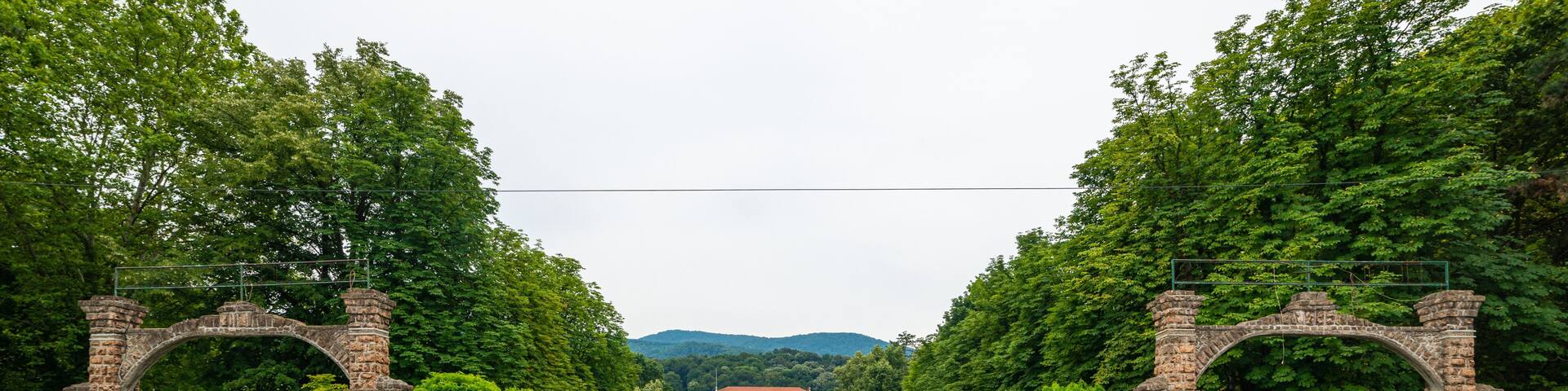 Banja Koviljaca, Serbia - July 13, 2019: Beautiful formal garden, park with trees, bush, flowers and architecture in medical wellness center Banja Koviljaca, leisure, disabilities and holiday
