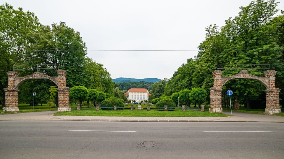 A historic archway with a building in the background.