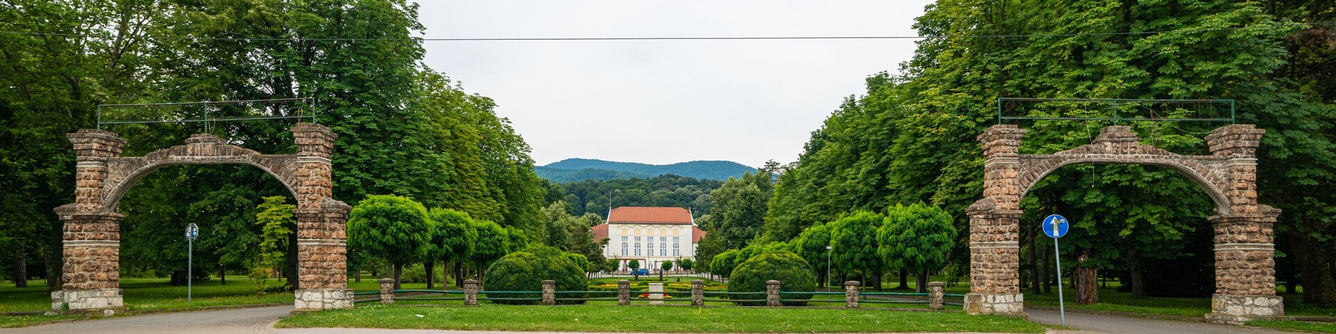 Banja Koviljaca, Serbia - July 13, 2019: Beautiful formal garden, park with trees, bush, flowers and architecture in medical wellness center Banja Koviljaca, leisure, disabilities and holiday