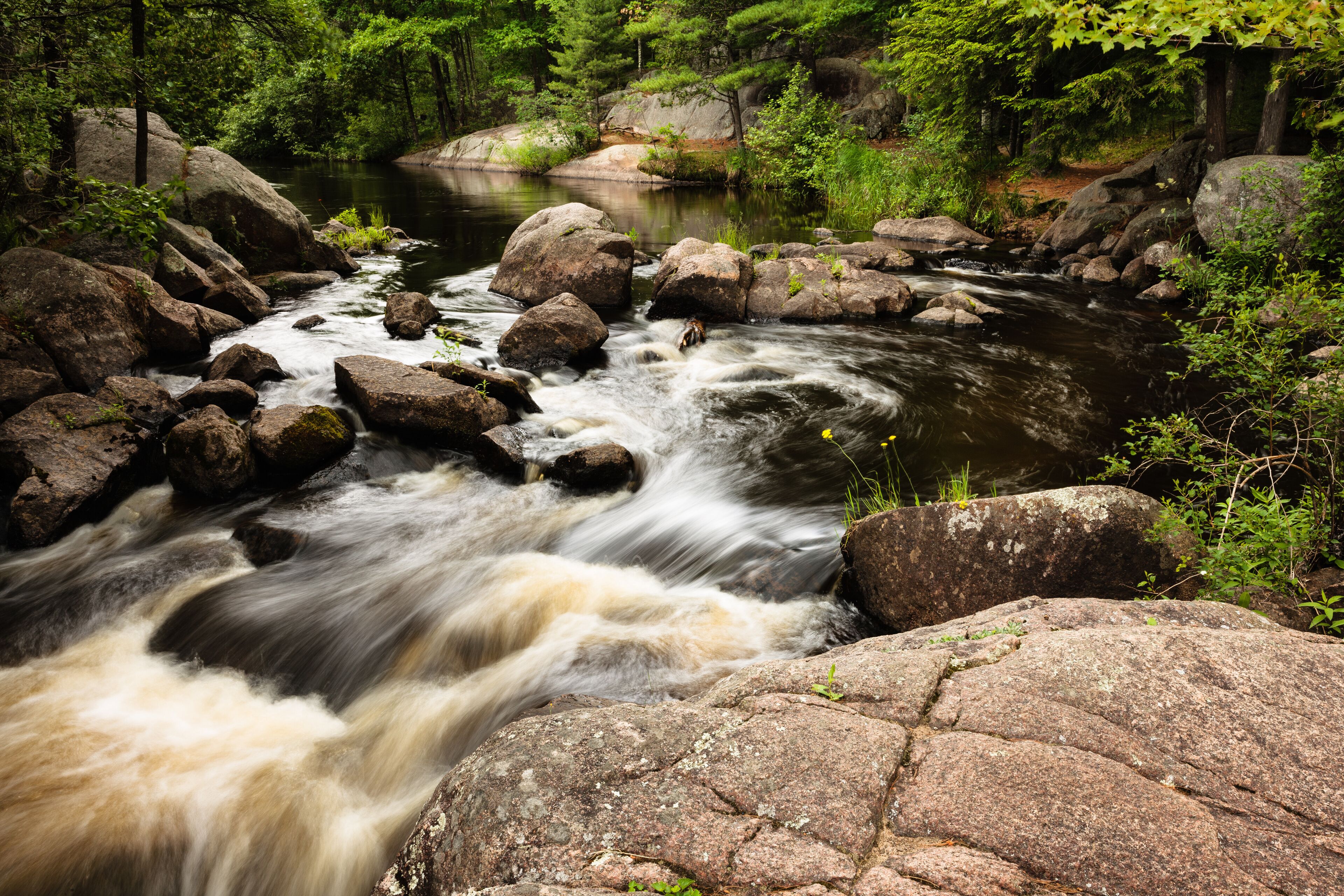 The  Pike River enters a small section of the upper falls at Dave's Falls Marinette County Park, Amberg, Wisconsin in early July