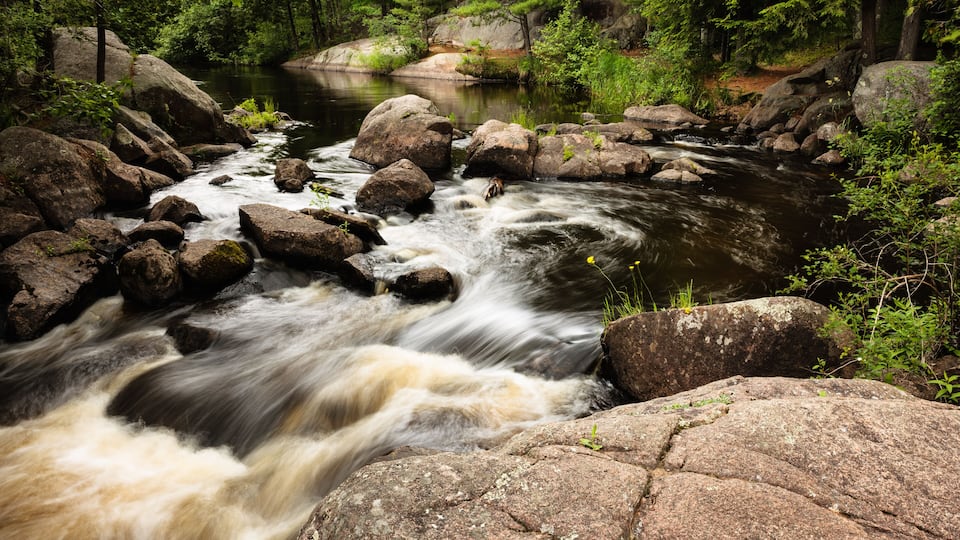 The Pike River enters a small section of the upper falls at Dave's Falls Marinette County Park, Amberg, Wisconsin in early July
