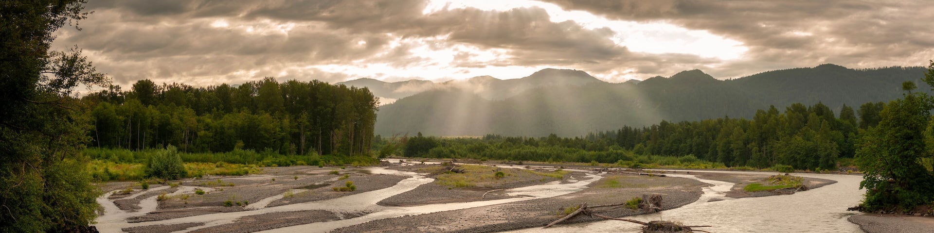 Nooksack River Sunrise. Light rays streaking across the North Cascade Mountains during a lovely sumertime sunrise.