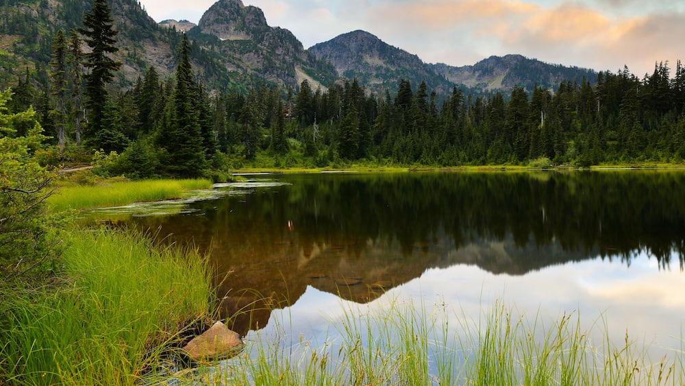 Mount Shuksan at sunset with reflection view from Picture Lake, Deming Washington. Picture Lake is the centerpiece of a strikingly beautiful landscape in the Heather Meadows area