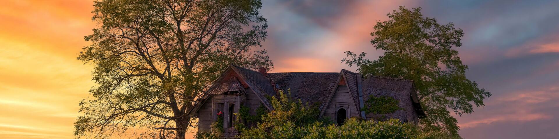 An old abandoned homestead known as the Guyitt House enjoys the beautiful sunset as it sits quietly in a field in rural Ontario by the shore of Lake Erie.