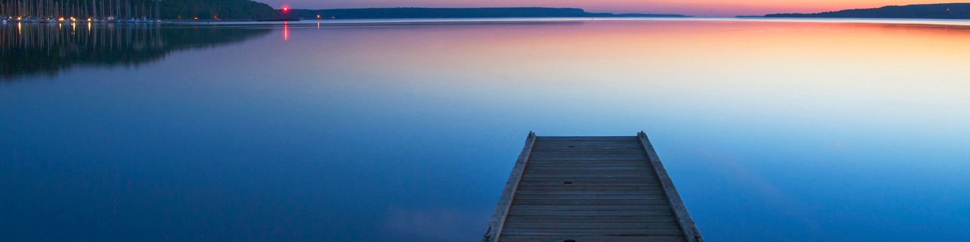 Wooden dock over still lake