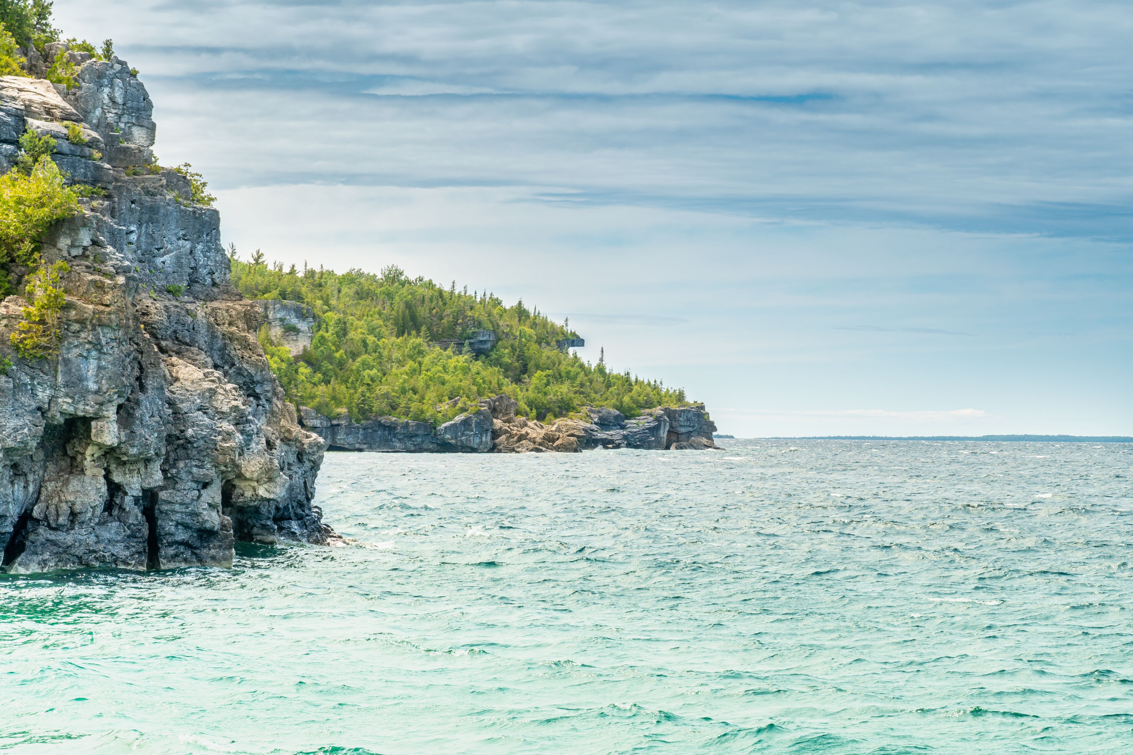 Colourful green waters at Indian Head Cove on lake Huron in Bruce Peninsula National Park and clear blue water in Ontario, Canada. Located between The Grotto and Overhanging rock tourist attractions.