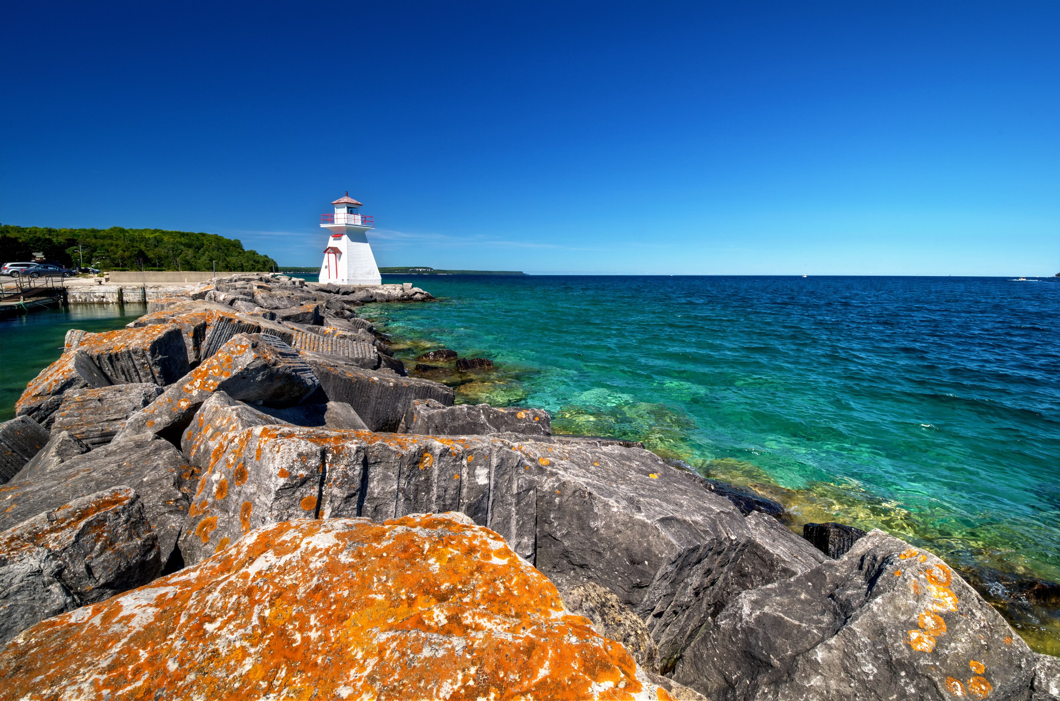 Rocks covered in yellow moss leading up to a lighthouse, crystal clear turquoise waters.; Shutterstock ID 483751123; Purchase Order: -