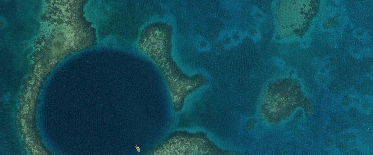 A large body of water surrounded by coral reefs and small islands.