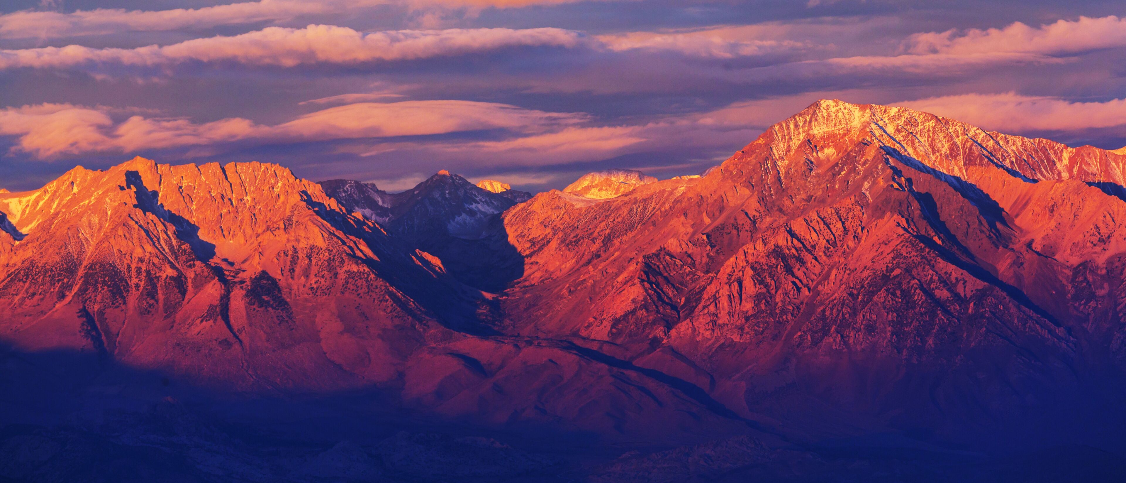 A mountain range with sharp peaks and a valley.