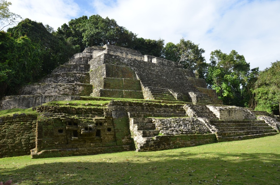 A large ancient pyramid with multiple levels and a surrounding forest.