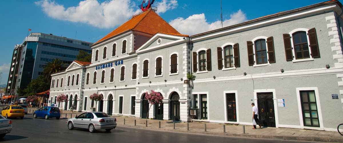 A historic building with a red roof and arched windows, a clock tower, and a sign reading "CASA MARENAR".