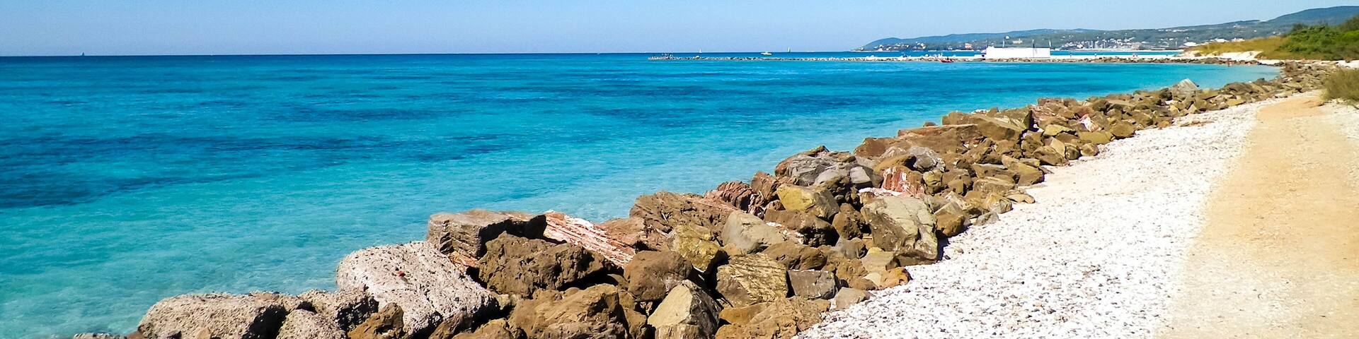 Breakwater on beach in Vada, Italy.