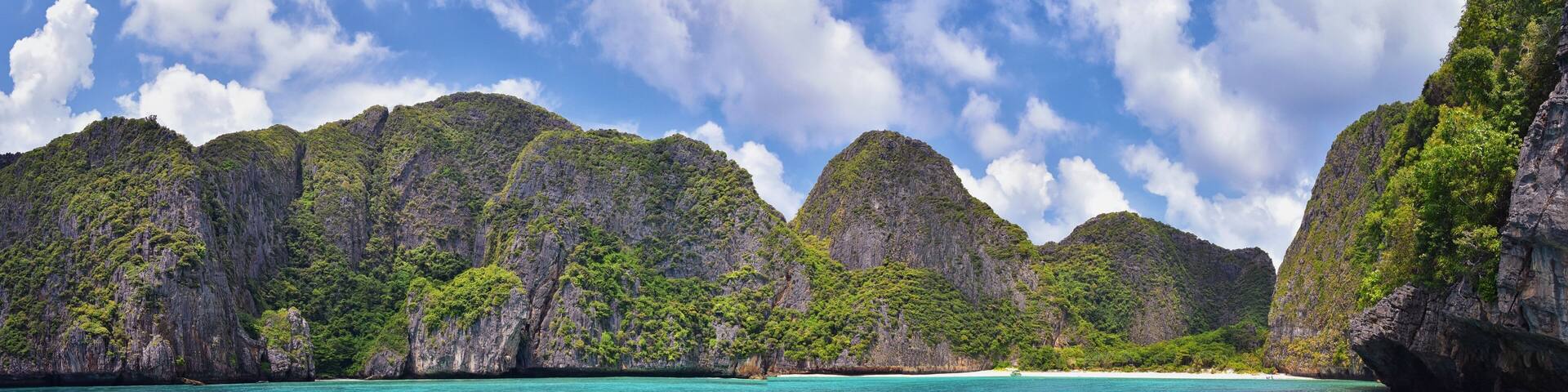 Island, Ocean views near Phuket Thailand with Blues, Turquoise and Greens oceans, mountains, boats, caves, trees resort island of phuket Thailand. Including Phi Phi, Ko Rang Yai, Ko Li Pe and other is