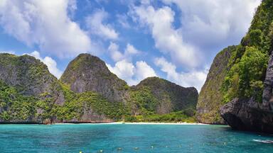 Island, Ocean views near Phuket Thailand with Blues, Turquoise and Greens oceans, mountains, boats, caves, trees resort island of phuket Thailand. Including Phi Phi, Ko Rang Yai, Ko Li Pe and other is