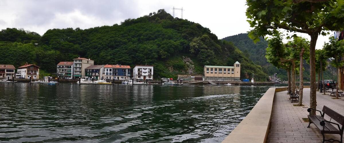 A river with boats, a bridge, and buildings along the banks.