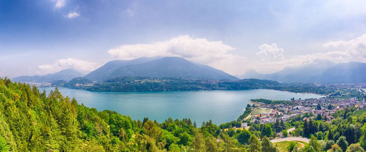 A lake surrounded by mountains and a town.