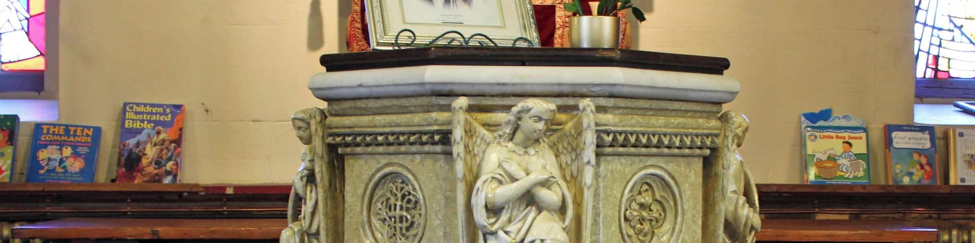 Elaborate font under the organ loft at the west end