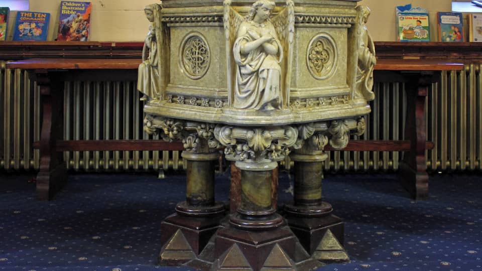 Elaborate font under the organ loft at the west end