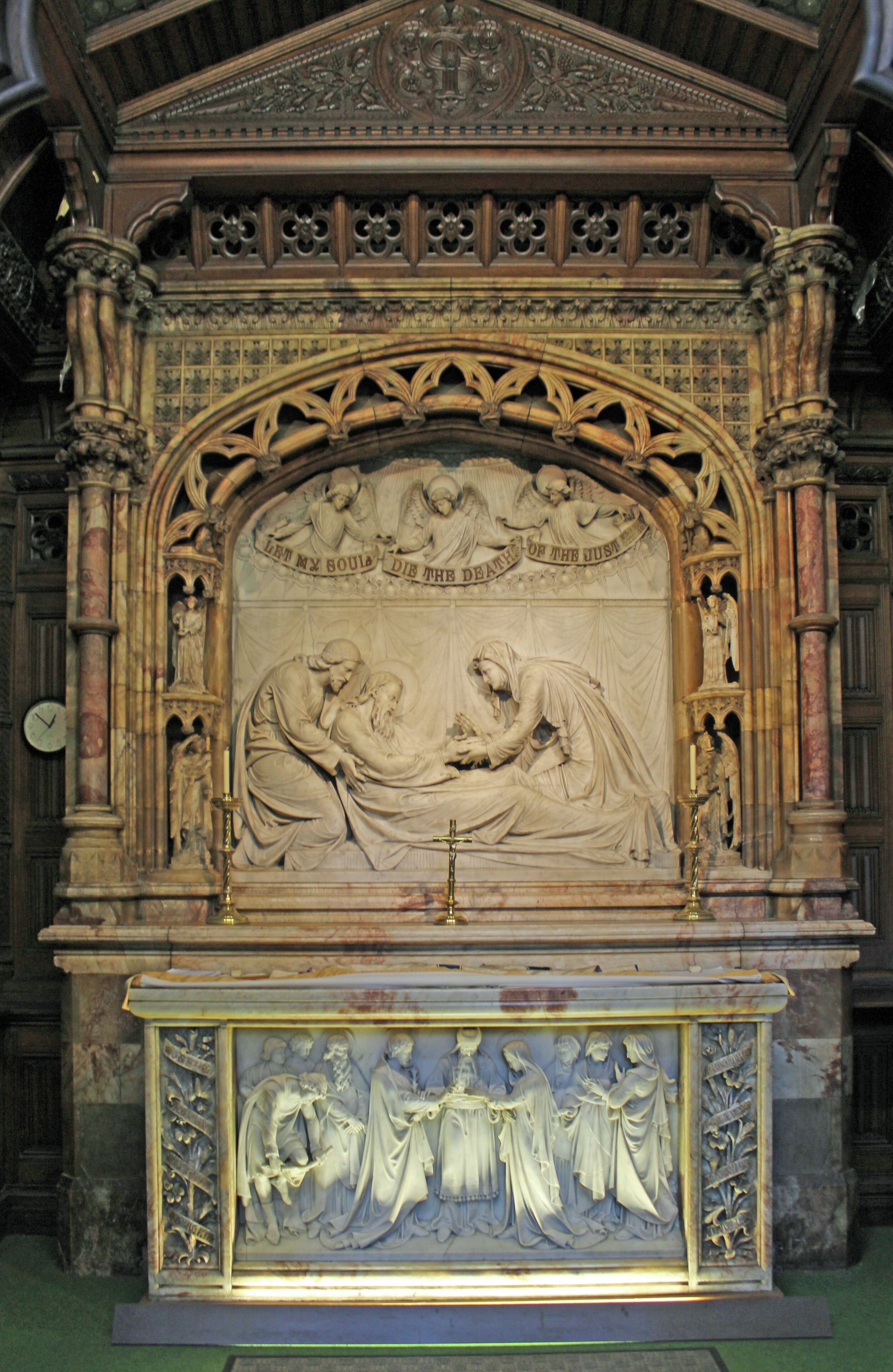 Marble altar to St Joseph showing in relief, his death surrounded by supplicants for his soul.