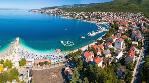 Tourist town of Selce and Poli Mora turquoise beach aerial panoramic view