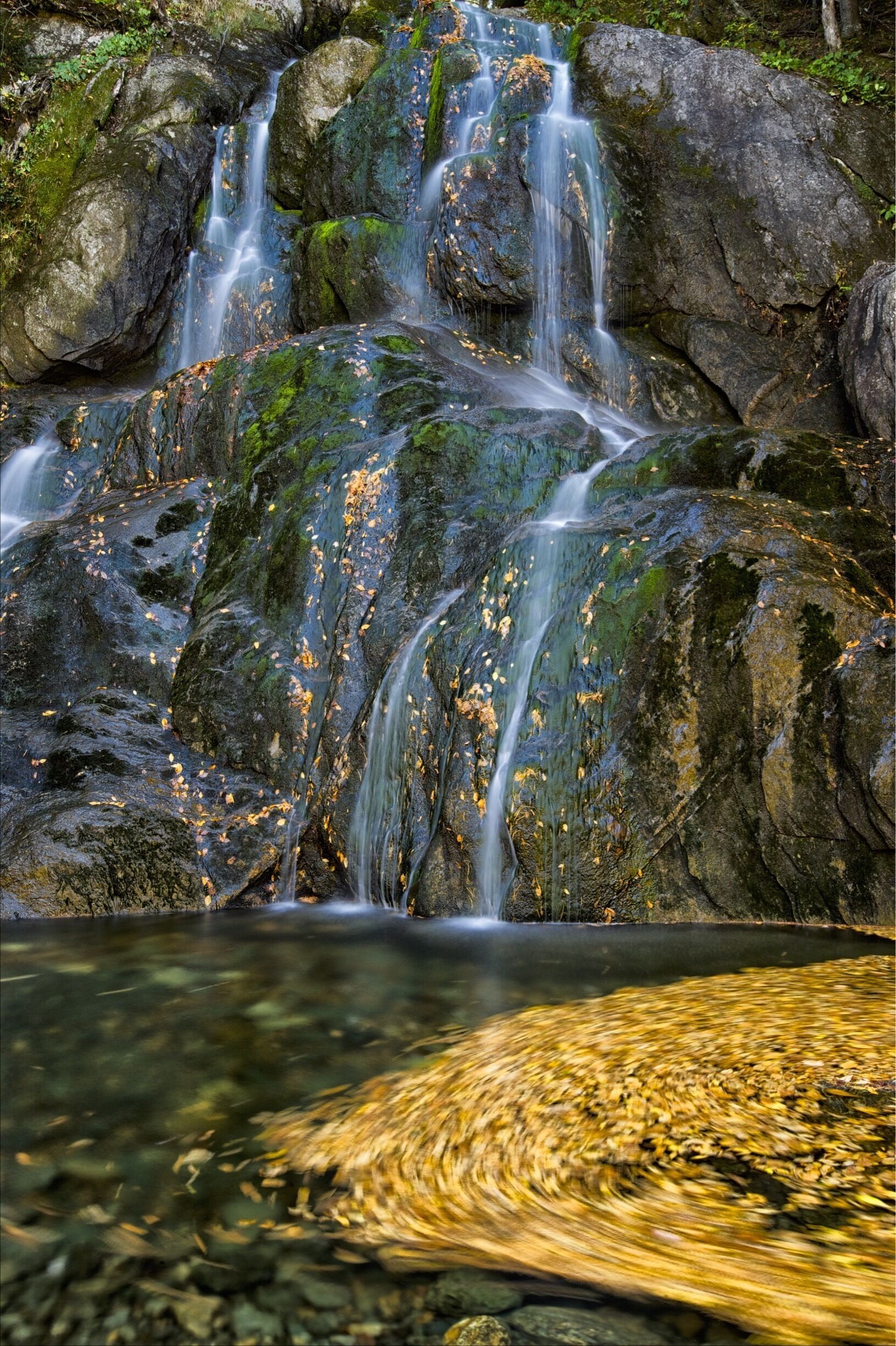 This is a popular waterfall turnout on Hwy 100 near Warren, VT. I wanted to illustrate it in a different way so I balanced the waterfall in top left area of frame with the leaves swirling in an Eddie at lower right.