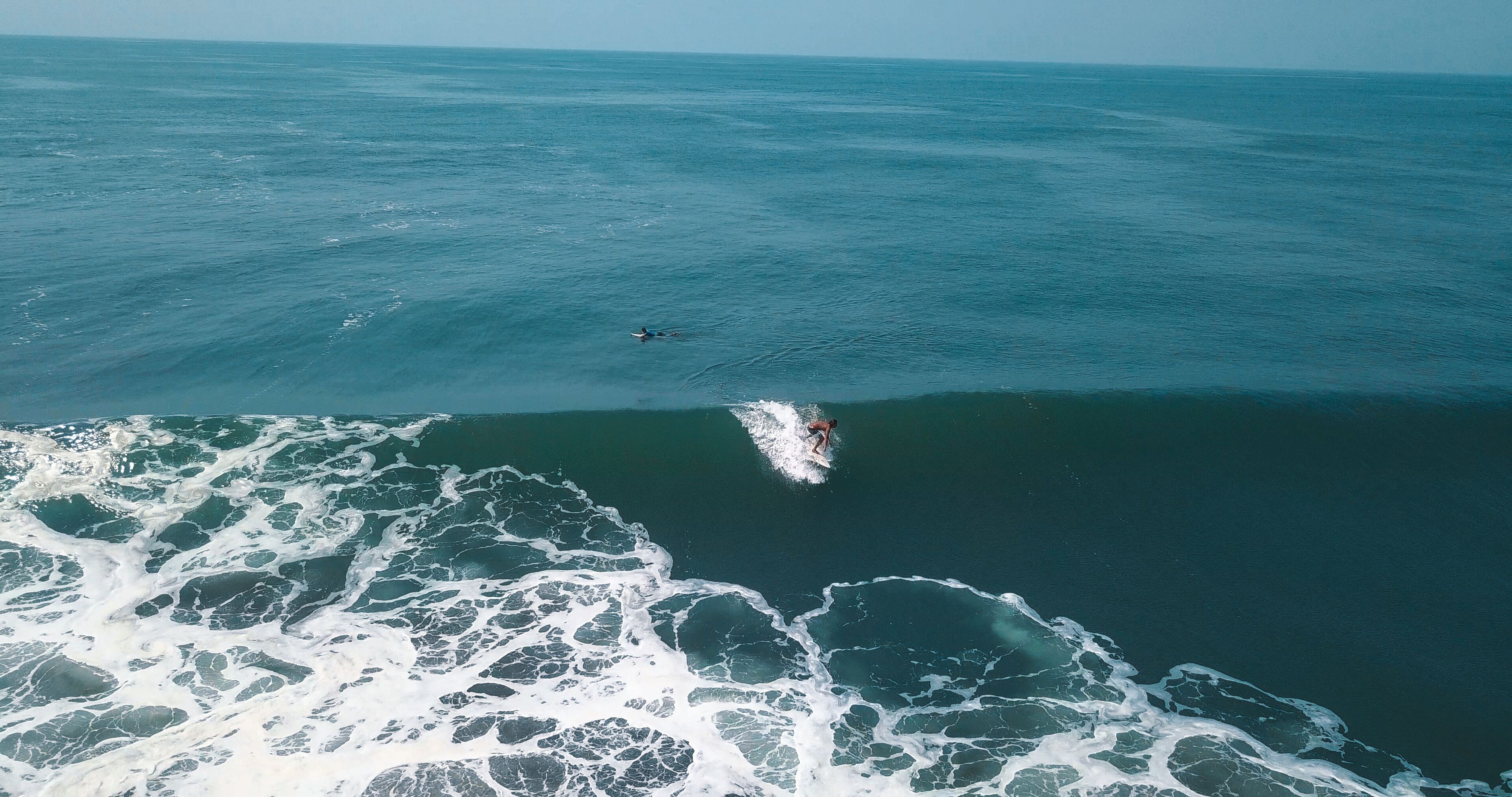 A surfer riding a wave in the ocean.