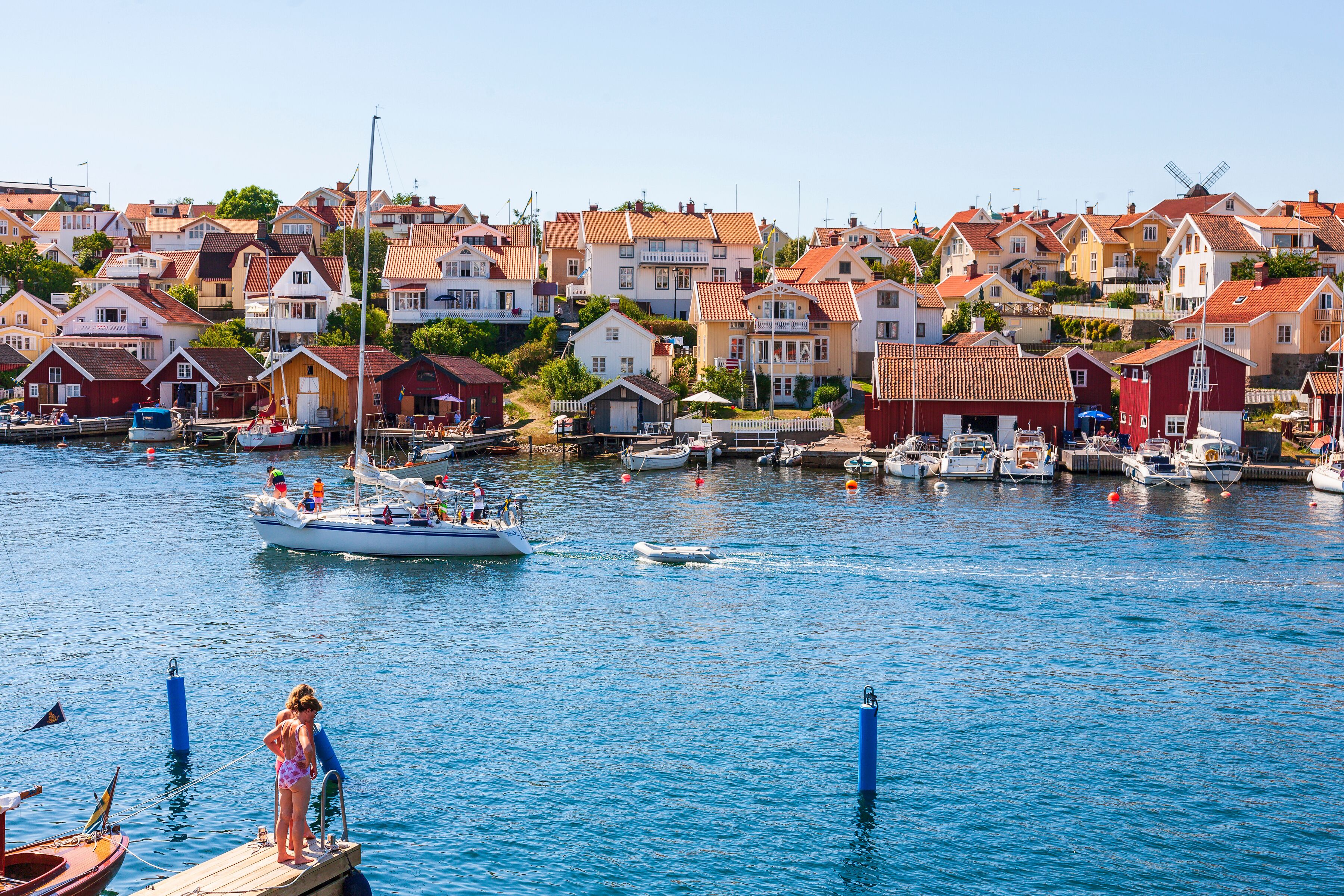Women at a jetty in Fiskebackskil an old swedish fishing village
