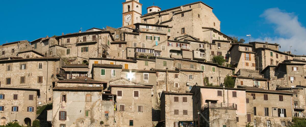 A historic town with a prominent clock tower and layered buildings.