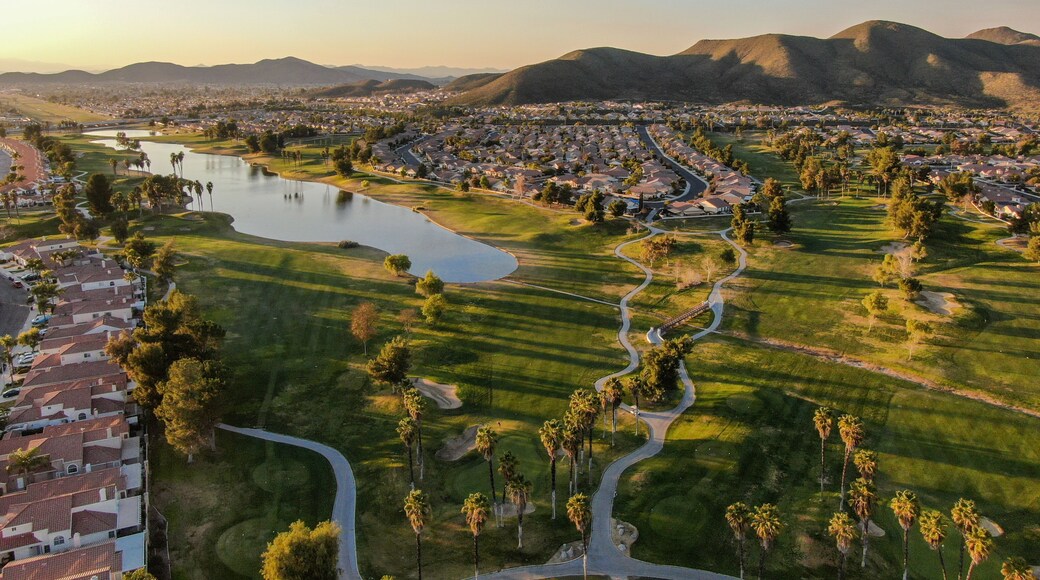 Aerial view of golf course surrounded by town houses and luxury villas during sunset time. Temecula, California, USA