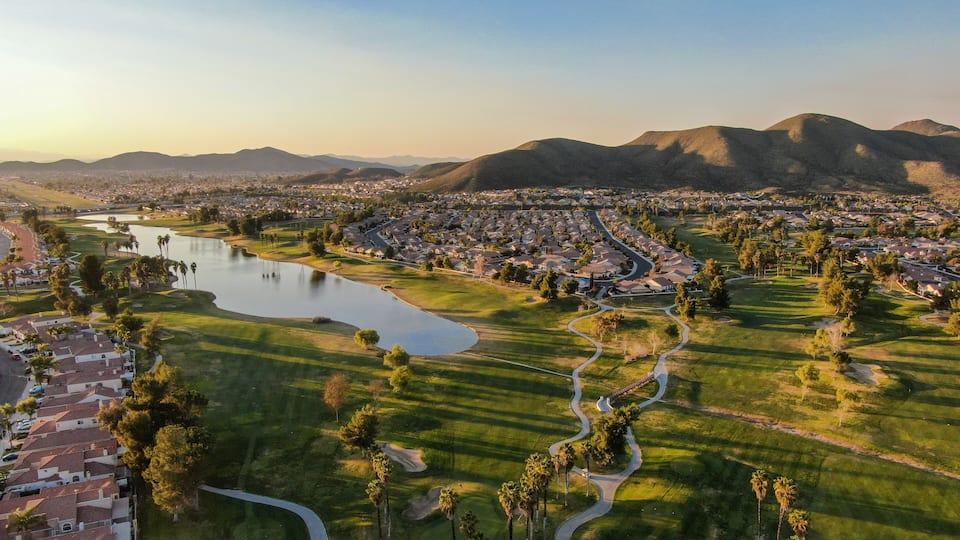 Aerial view of golf course surrounded by town houses and luxury villas during sunset time. Temecula, California, USA