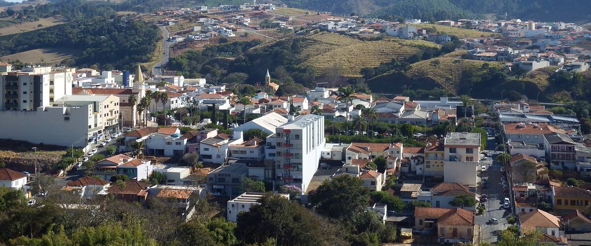 A town nestled in a valley with a prominent mountain in the background.