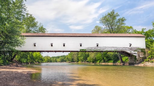 The white single span Jackson Covered Bridge crosses Sugar Creek in rural Parke County, Indiana