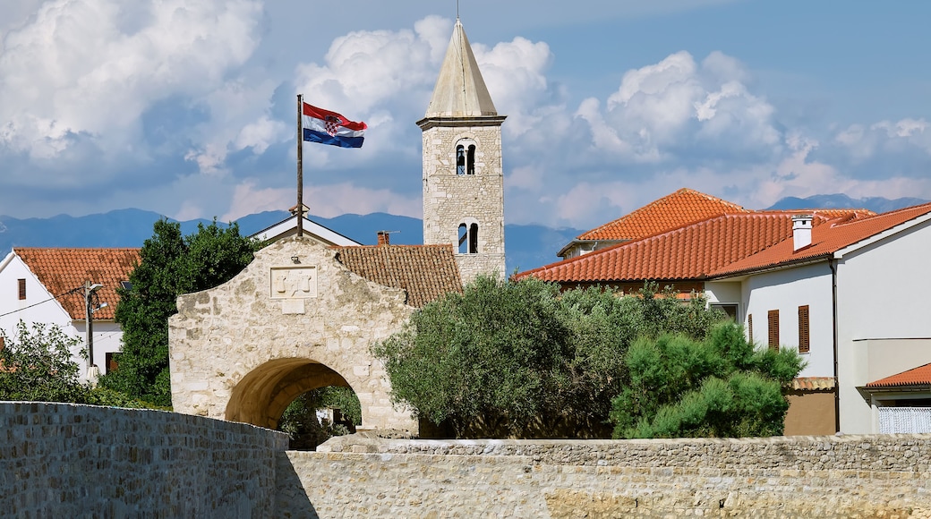 Nin, historic medieval town in the Zadar County of Croatia. Entrance gate and stone bridge that leads to city center. Nin is on the island on lagoon on the Adriatic Sea.