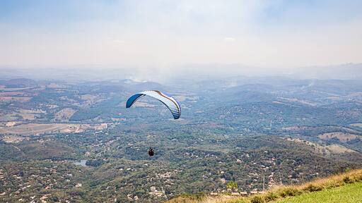 Belo Horizonte, Minas Gerais, Brazil. Paraglider flying from top of the world mountain