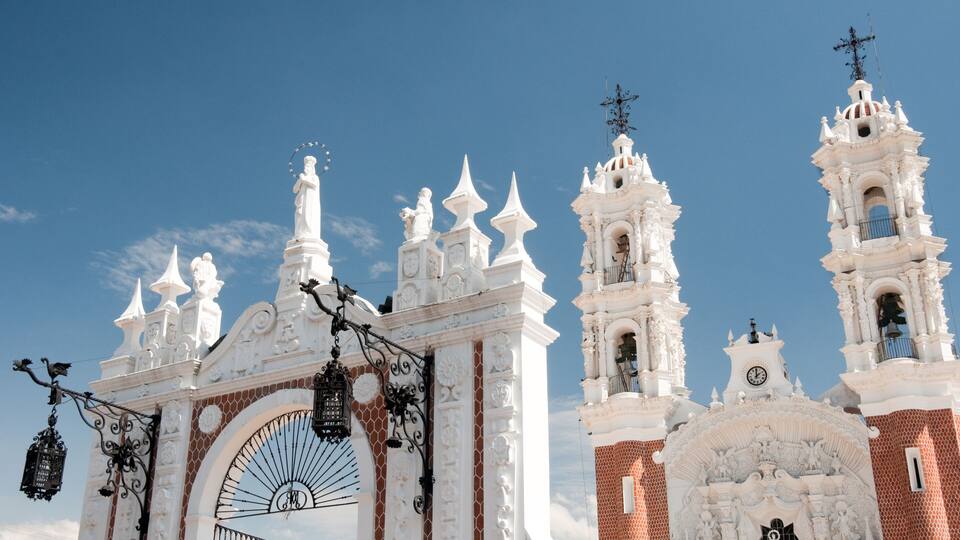 A white church with ornate architecture and a large arched entrance.