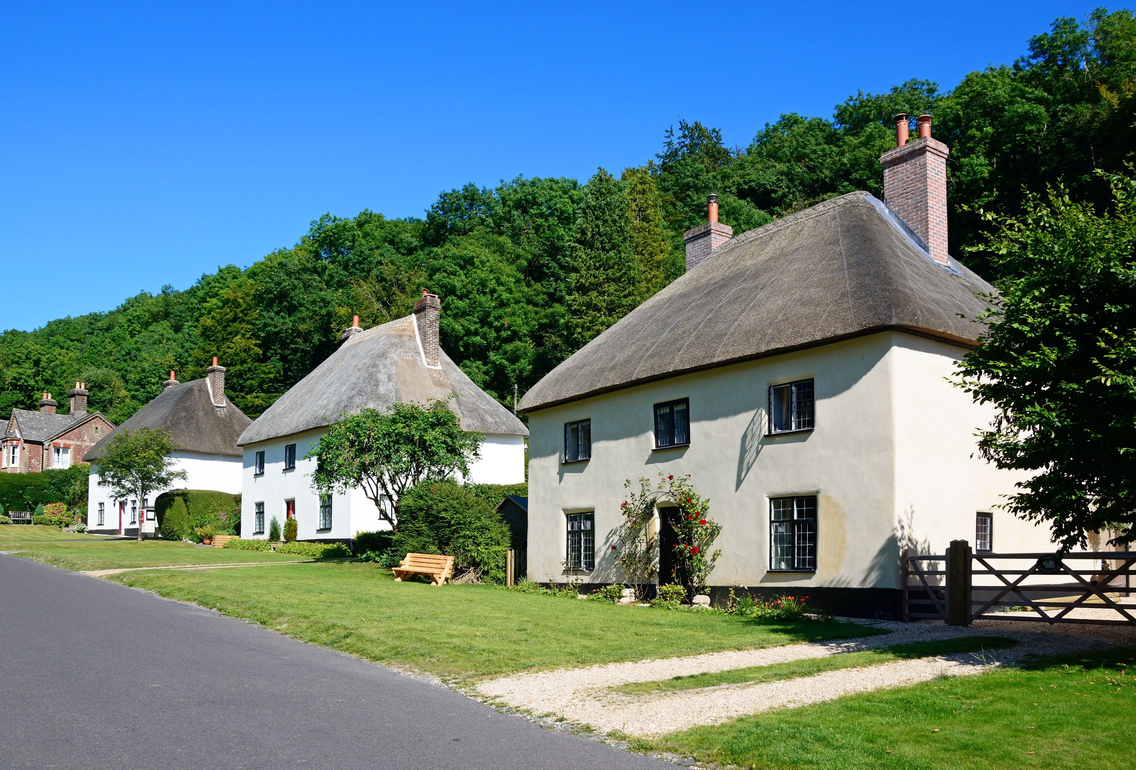 View along the pretty village street with thatched cottages, Milton Abbas.