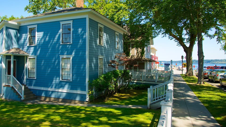 A blue house with a porch and a small garden.