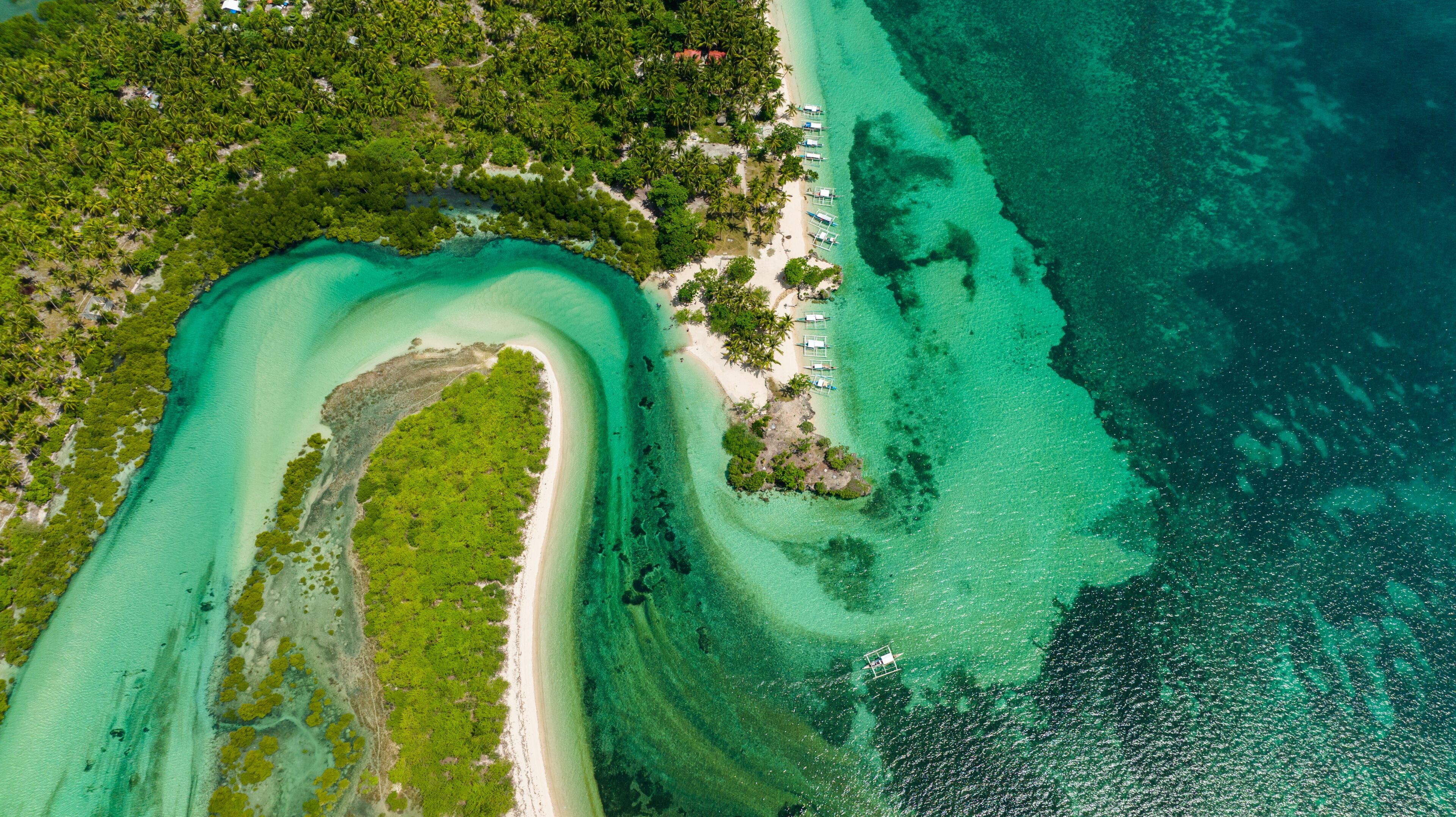 Top view of blue lagoon with islands in turquoise water. Tropical landscape. Balidbid Lagoon, Bantayan island, Philippines.